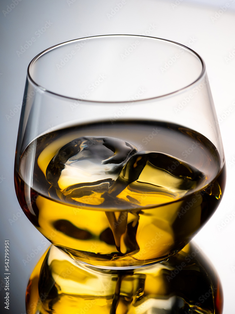 Whisky on the rocks, glass filled with ice cubes, close-up shot
Whisky on the rocks, glass filled with ice cubes, close-up shot