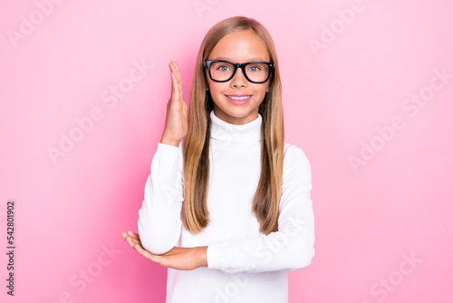 Photo of cheerful intelligent girl toothy smile raise arm know answer isolated on pink color background