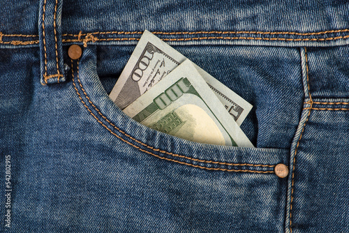 Stack of 100 dollar bills in jeans pocket. Money in the front pocket of jeans. The concept of investment, cash, wealth and profit
