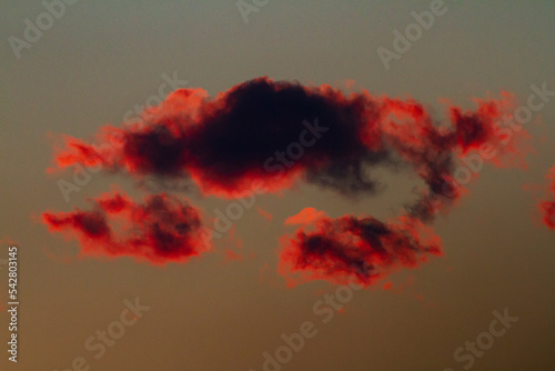 red and dark cloud details taken in backlight at sunset photo