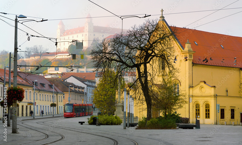 Early morning in center of Bratislava with tramline and historic architecture..