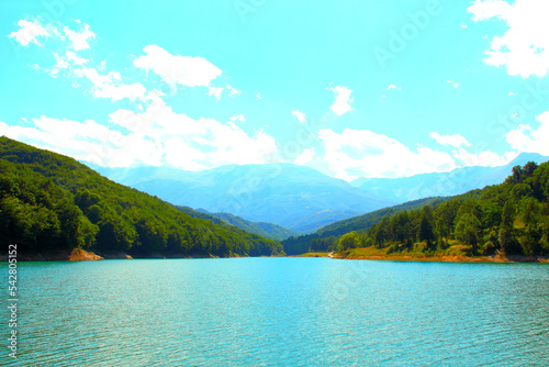 Fotografie Enchanting scene at Gerosa Lake with the misty outlines of the Sibillini mountai