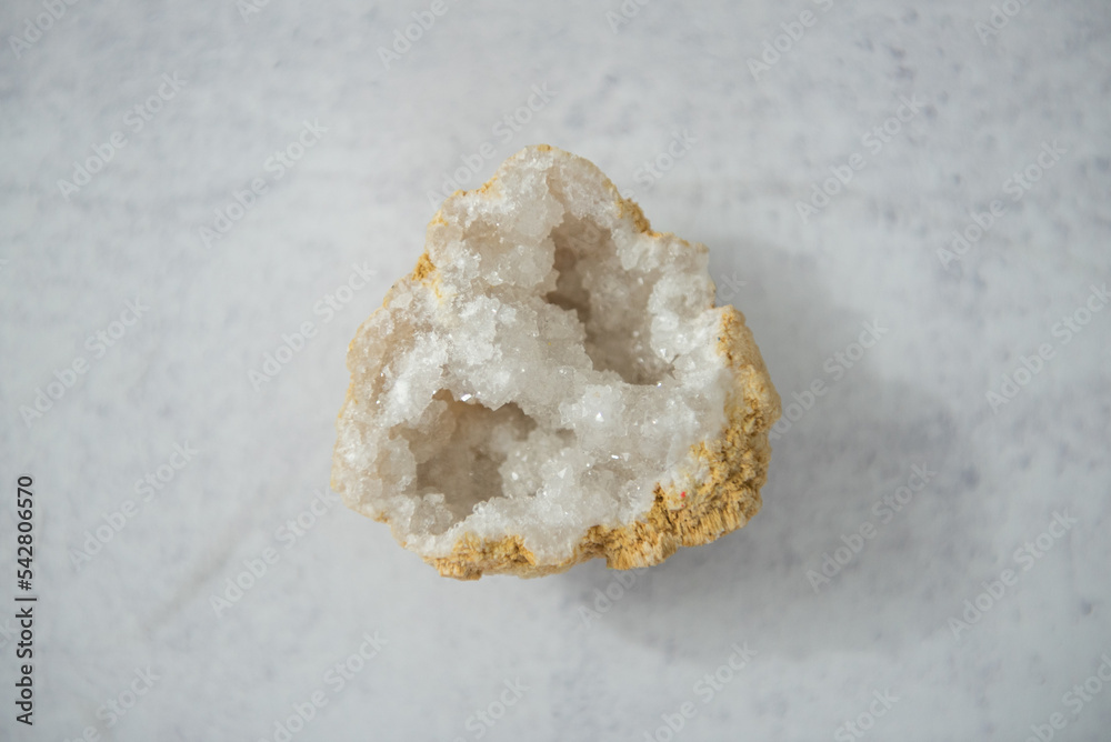 Inside geode white crystals on concrete background Inside geode white crystals on concrete background
