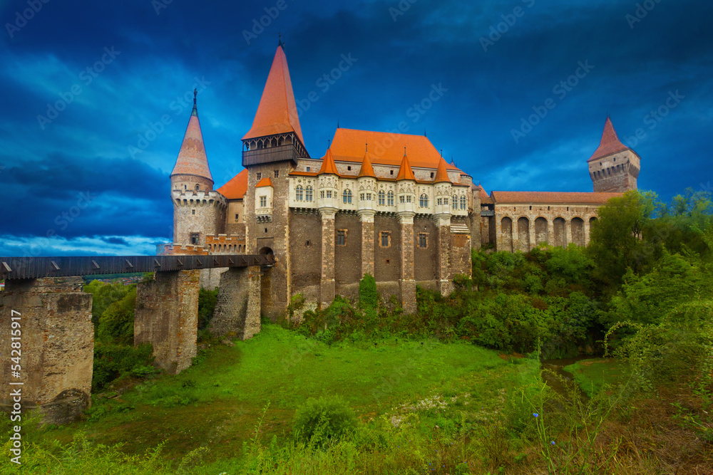 Corvin Castle is on the green mountain of Romania.