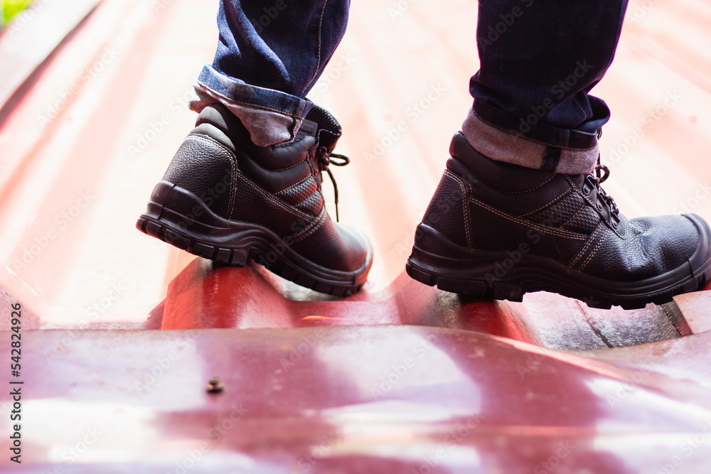 Foto de Wear safety shoes to ensure safety at work. construction workers wear safety shoes