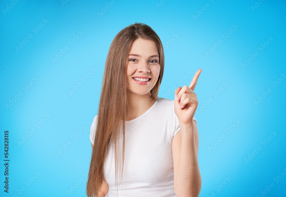 Beautiful young woman indicates something with a hand Beautiful young woman indicates something with a hand