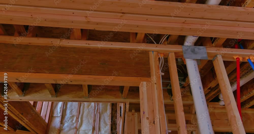 Building frame for new residential building while it is still under construction with beams fenestrations on construction site