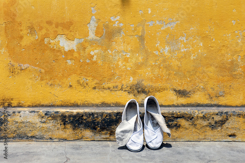 Washed shoes against a background of yellow wall, Vietnam, Hoi An