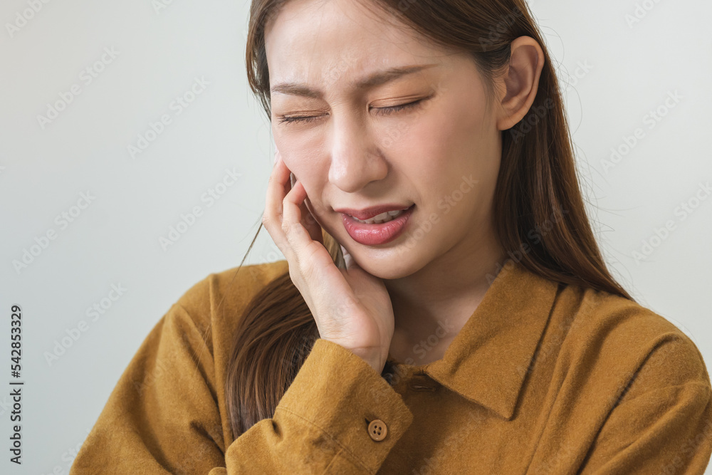 Face expression suffering from sensitive teeth and cold, asian young woman, girl feeling hurt