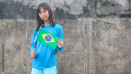 a little girl with the brazil flag
