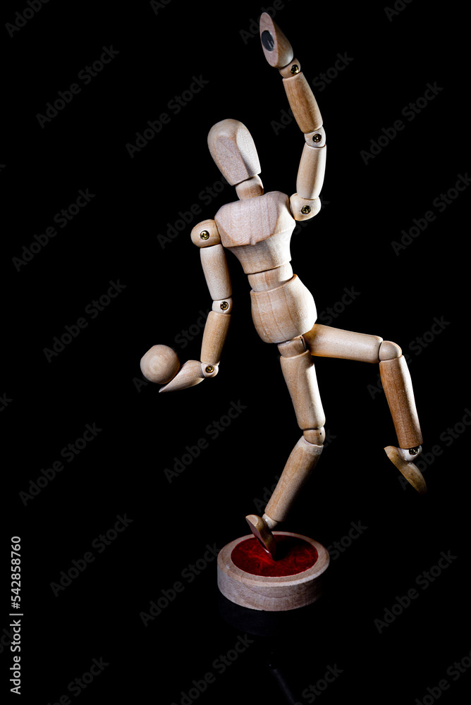 Image of wooden manikin on black background poses different posing Image of wooden manikin on black background poses different posing