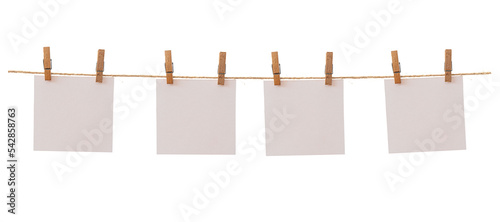 Billede på lærred Four frames that hang on a rope with clothespins and isolated on white