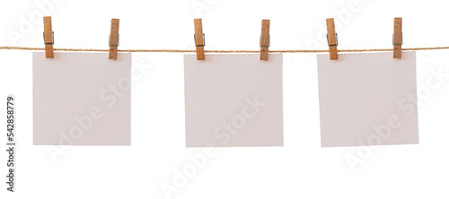 Bild auf Leinwand Three frames that hang on a rope with clothespins and isolated on white