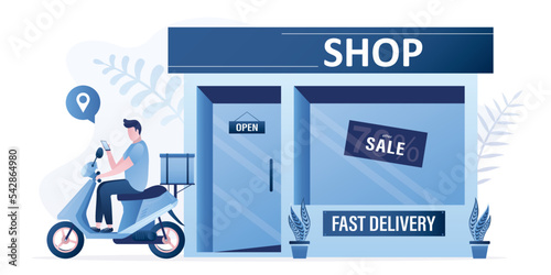 Fast delivery of goods or food from store. Male courier on motorbike drives off from door of the store. Online trade, e-commerce. Delivery service delivers boxes of goods to customers.