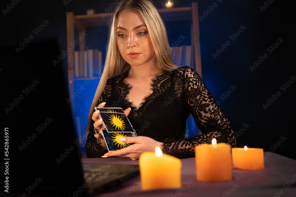 Psychic Tarot card reader on laptop computer while having an online session Psychic Tarot card reader on laptop computer while having an online session