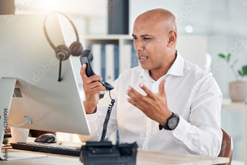 Call center, customer service and arguing with a frustrated man at work in a telemarketing office. Contact us, consulting and angry with an annoyed male working as a sales, support or crm agent