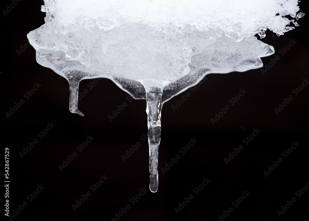An icicle hangs from the snow. An icicle hangs from the snow.