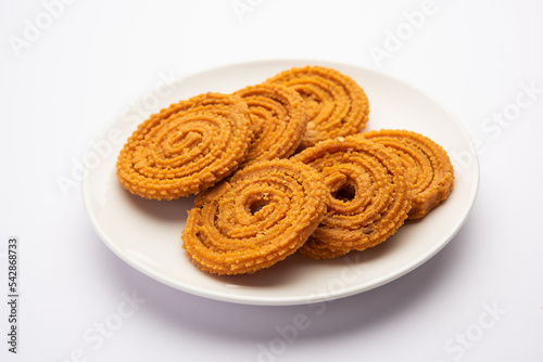 Chakli is a savoury snack from India. It is a spiral shaped snack with a spiked surface photo