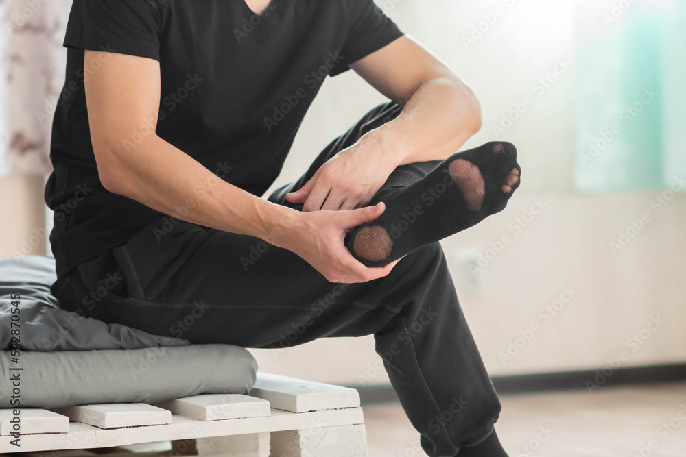 Ταπετσαρία An old worn black sock on a man. Closeup