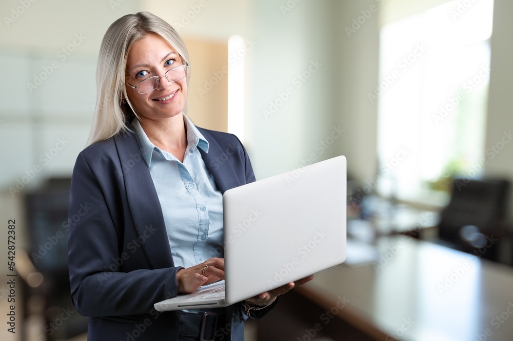 Naklejka premium Young happy successful businesswoman works in office