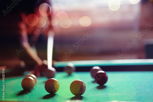 Billiard balls and cue on pool table. Russian billiards. Close-up of items for the game. Background space. Concept of sports games. Place for an inscription or logo. Copy space for site or banner