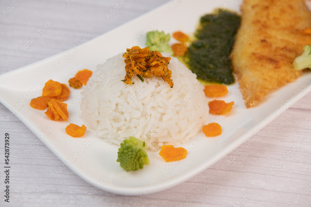 Recipe for Hake fillet breaded with panko, rice, carrot chips and coriander sauce. High quality photo Recipe for Hake fillet breaded with panko, rice, carrot chips and coriander sauce. High quality photo