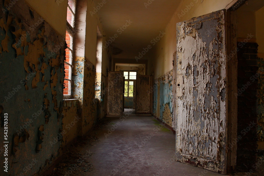 Lost place, old abandoned House with a hallway, windows and open doors