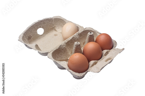 Open egg box with three brown eggs and one white egg isolated. Fresh organic chicken eggs in carton pack. copy space