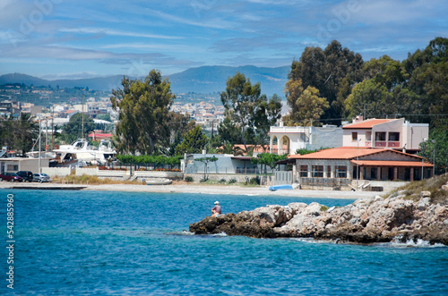 view from the sea. Fisherman and the beach in Eretria town .Evia island,Greece