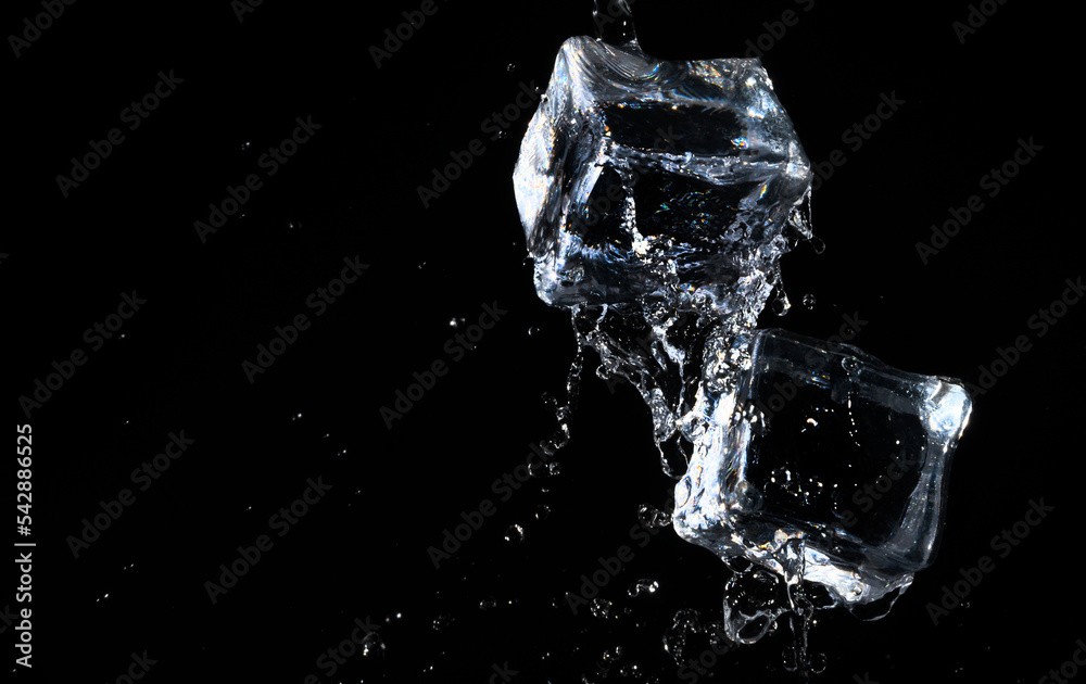 ice cube in water jet on black background ice cube in water jet on black background