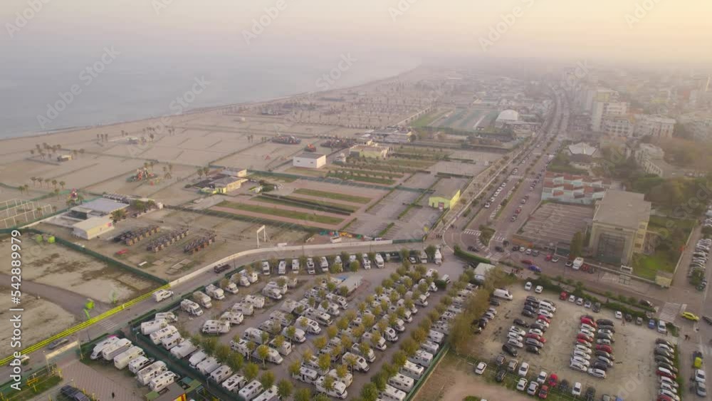 View from the drone of a city on the shore of the Mediterranean sea in the evening at sunset. Fall season, off-season. View from the drone of a city on the shore of the Mediterranean sea in the evening at sunset. Fall season, off-season.