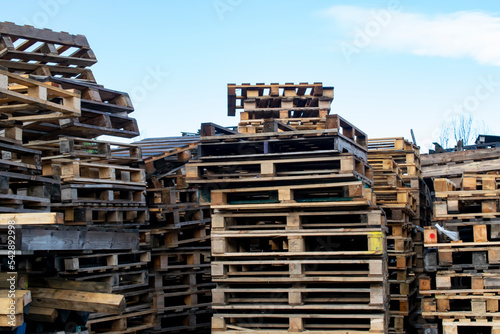 stacks of wooden pallets against the sky