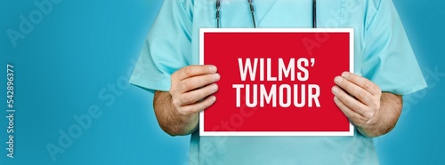 Wilms’ tumour. Doctor shows red sign with medical word on it. Blue background.