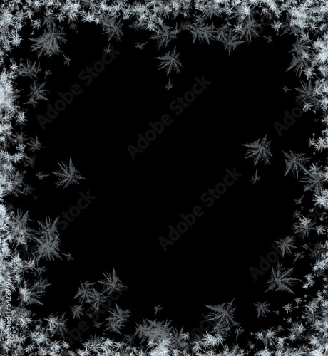 A frame of a frosty pattern  on a black background. A frame with an abstract ice structure allows you to apply or add a frost effect. Frost on the glass, freezing effect