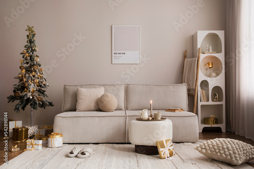 Domestic and cozy christmas living room interior with corduroy sofa, white shelf, mock up poster frame, christmas tree, decoration, wreath, gifts and accessories. Home decor. Family time. Template. photo
