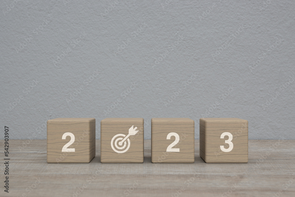 2023 letter with goal icon on wood block cubes on wooden table over white wall background, Happy new year 2023 success concept 2023 letter with goal icon on wood block cubes on wooden table over white wall background, Happy new year 2023 success concept
