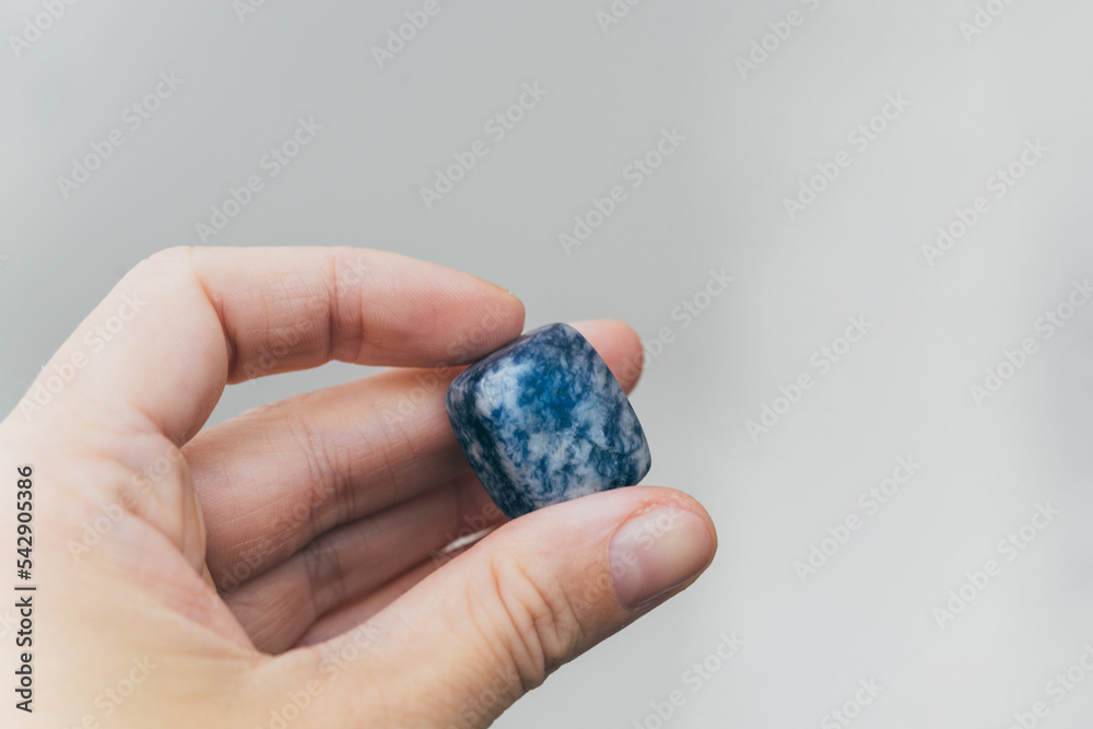 Hand holding blue quartz healing crystal Hand holding blue quartz healing crystal