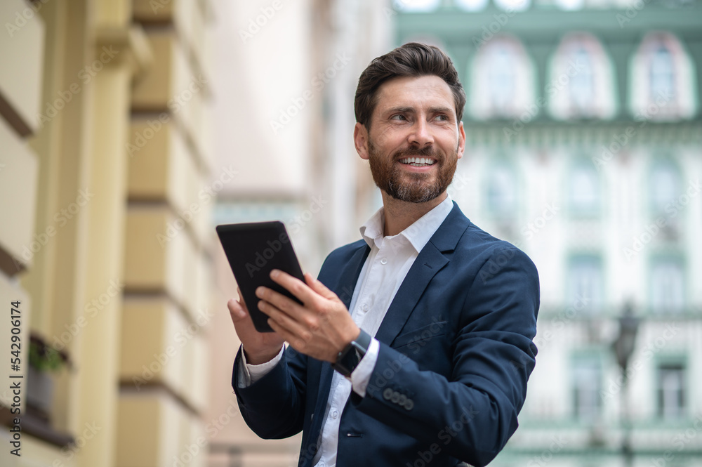 Young businessman with a tablet in hands having a video call Young businessman with a tablet in hands having a video call