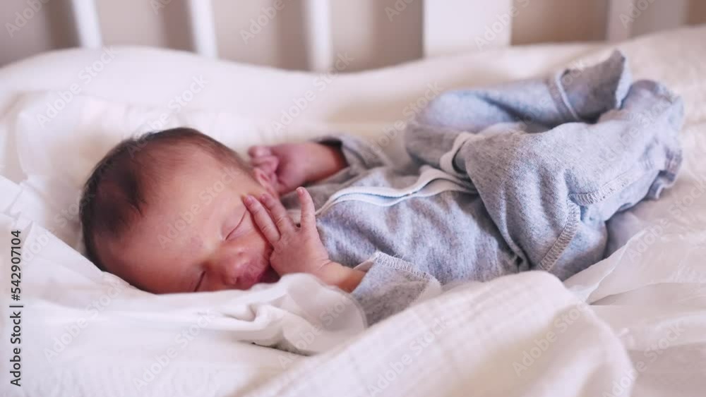 newborn baby sleeping. cute a newborn baby sleeping in bed close up in maternity