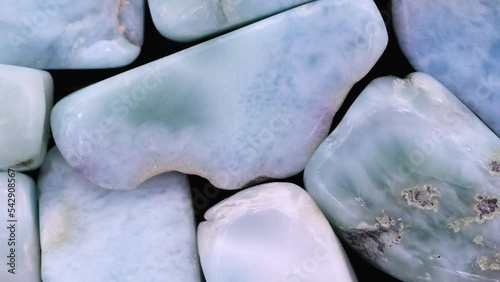 Larimar jewel heap texture. Pile mineral pebbles background. Moving right seamless loop backdrop. photo