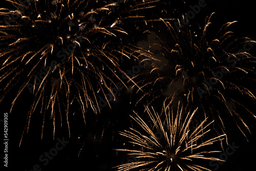 Golden amazing fireworks isolated on a dark background as a backdrop. Independence Day, New Year, explosion. Beautiful colorful fireworks festive fireworks in the night sky. copy space