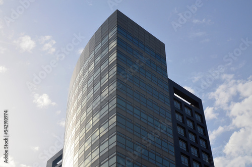 Exterior of beautiful modern skyscraper against blue sky  low angle view