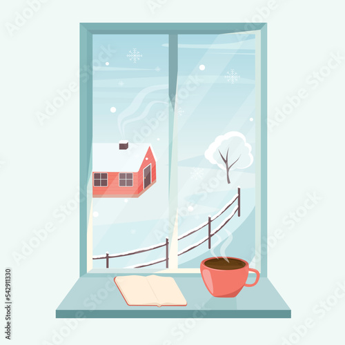 Winter window with a view of nature and village house with a cup of coffee and a book on the windowsill