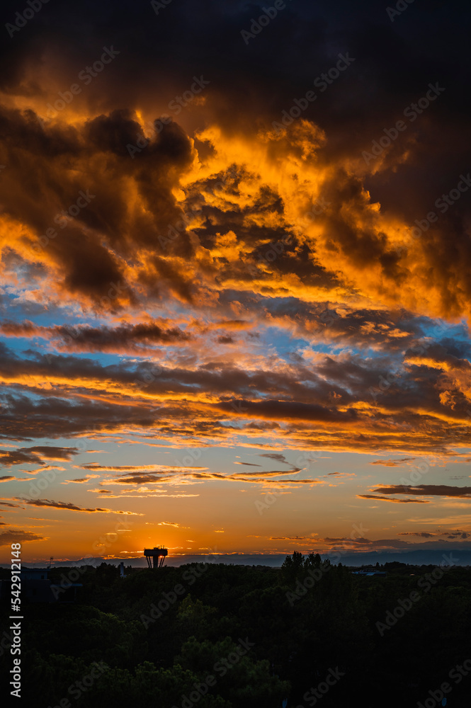 Games of clouds in a fiery sunset. The sky above Lignano Sabbiadoro