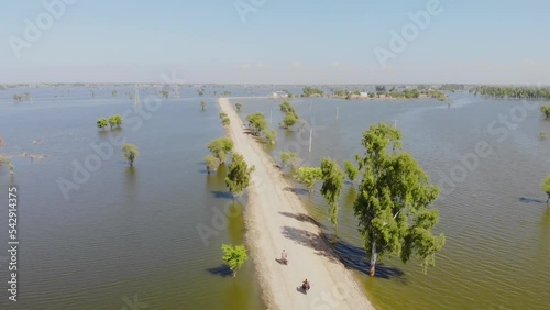 Aerial Along Lone Road Surrounded By Flood Waters Into The Horizon In Jacobabad, Sindh photo