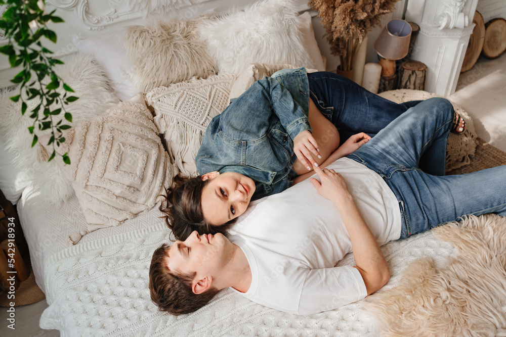 top view. pregnant woman and man. a couple in the bed. parenthood top view. pregnant woman and man. a couple in the bed. parenthood