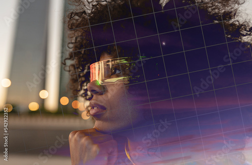 Thoughtful Afro woman wearing smart glasses photo