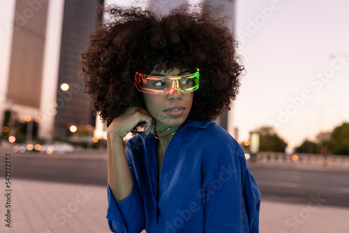 Woman with curly hair wearing smart glasses photo