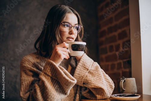 Young woman drinking coffee in a cafe