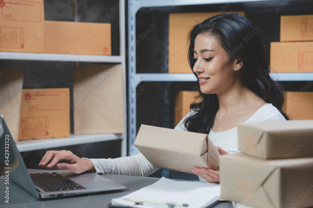 woman entrepreneur's hand holding package of parcel box, Preparing pack delivery packet product for selling online of home shipping service, Startup with small business marketing concept woman entrepreneur's hand holding package of parcel box, Preparing pack delivery packet product for selling online of home shipping service, Startup with small business marketing concept